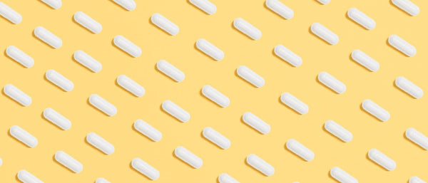 white pills on a yellow background